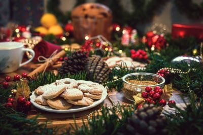Italian Christmas cookies on a table with pinecones, berries, and garland